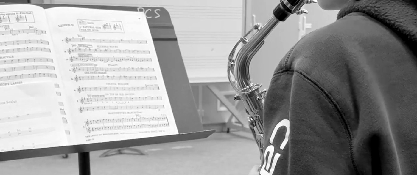 Alto-sax student reading from a Breeze Easy lesson book