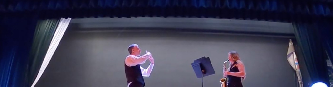 Saxophone soloist on stage with Mr. Brown conducting
